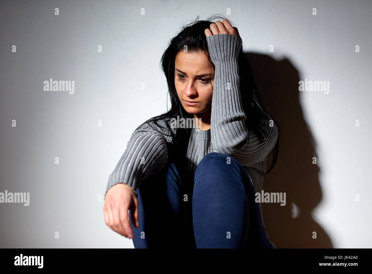 unhappy woman crying on floor Stock Photo - Alamy