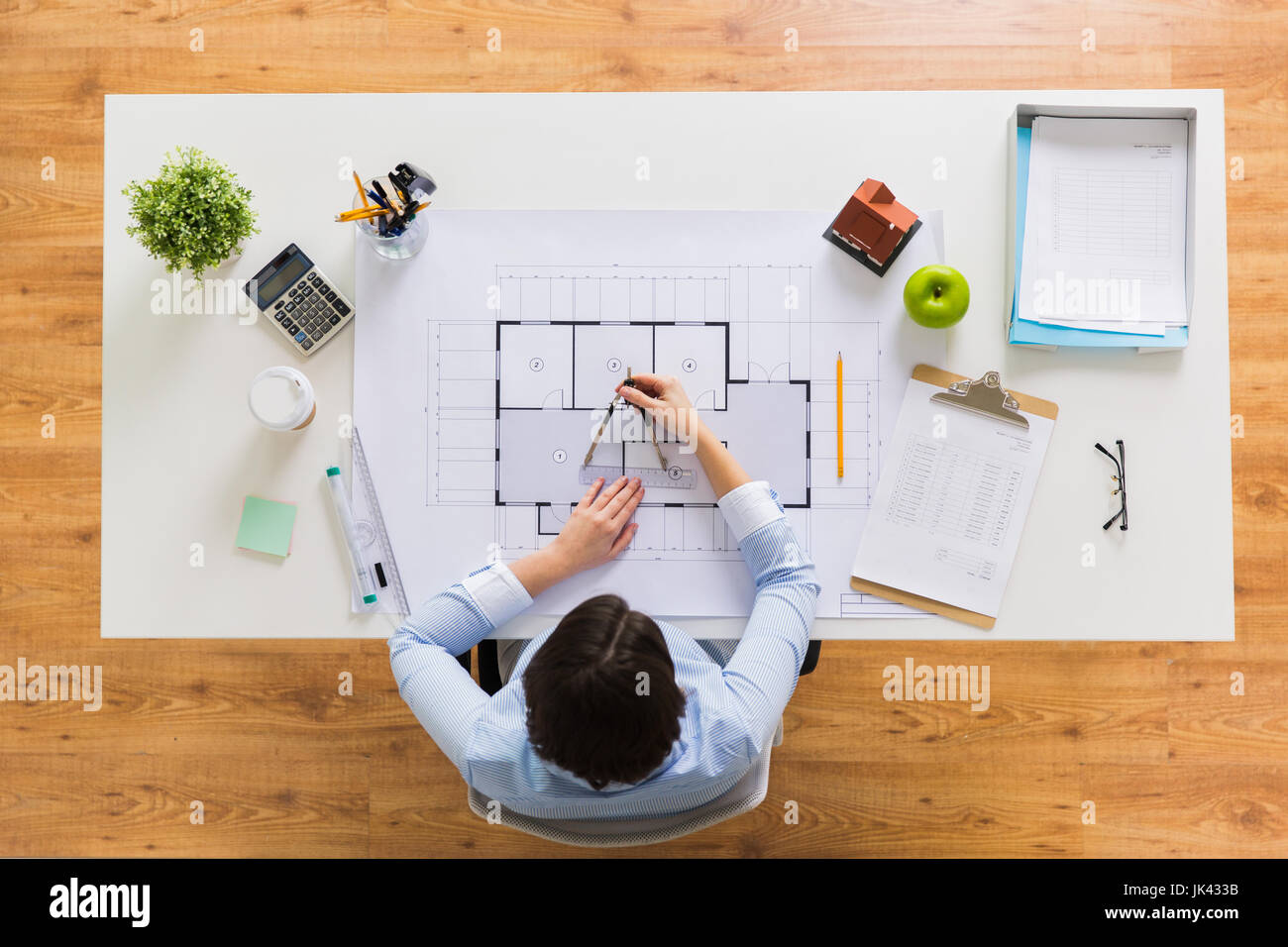 architect with compass measuring blueprint Stock Photo