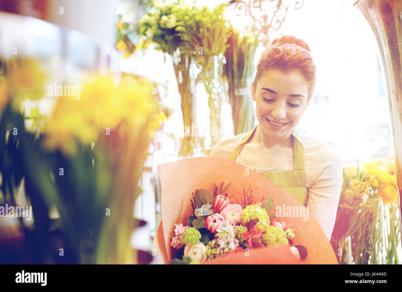 smiling florist woman with bunch at flower shop Stock Photo - Alamy