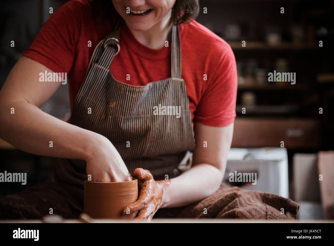 Caucasian woman shaping pottery clay Stock Photo