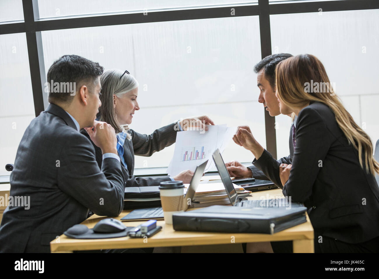Business people examining chart in meeting Stock Photo