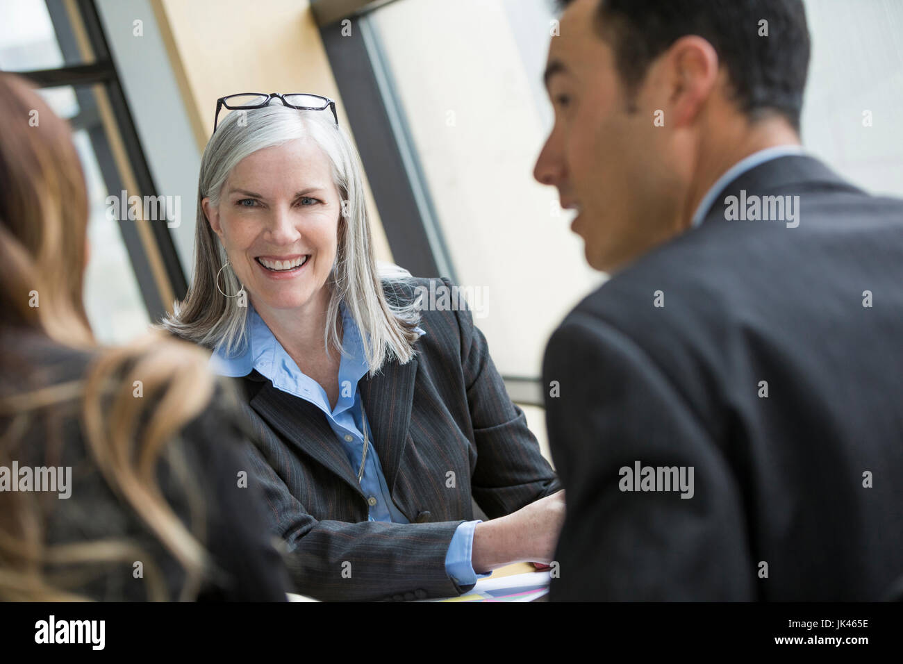 Portrait of smiling businesswoman in meeting Stock Photo