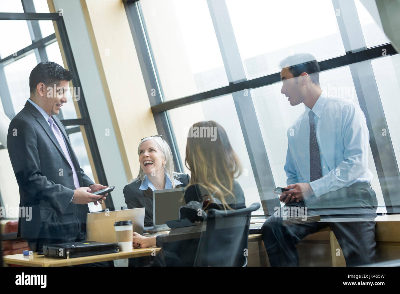 Business people laughing in meeting Stock Photo