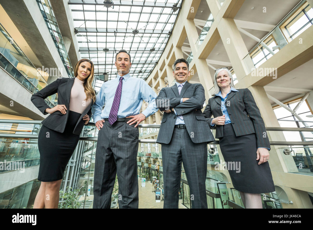 Portrait of smiling business people in lobby Stock Photo