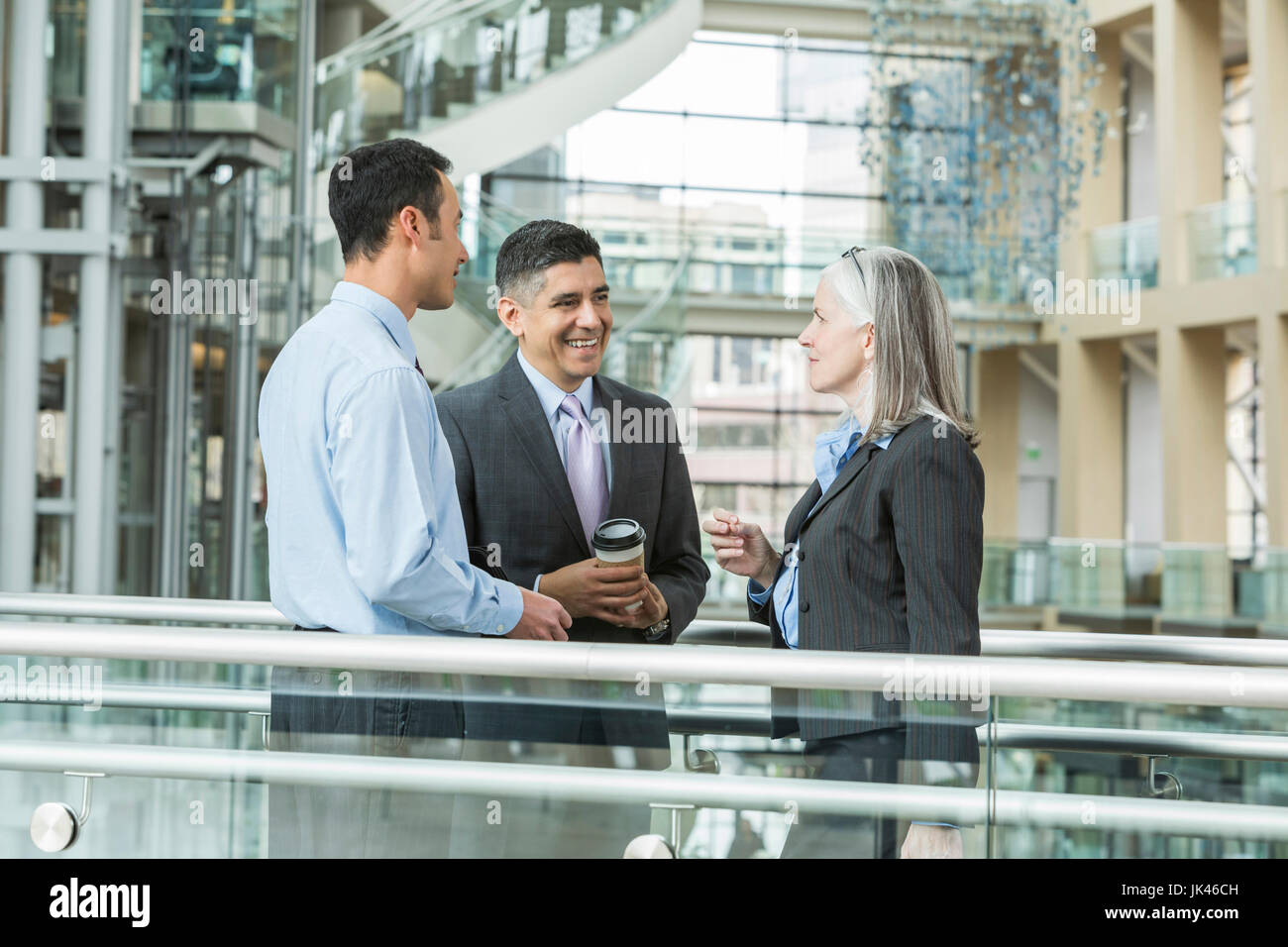 Business people talking in lobby Stock Photo