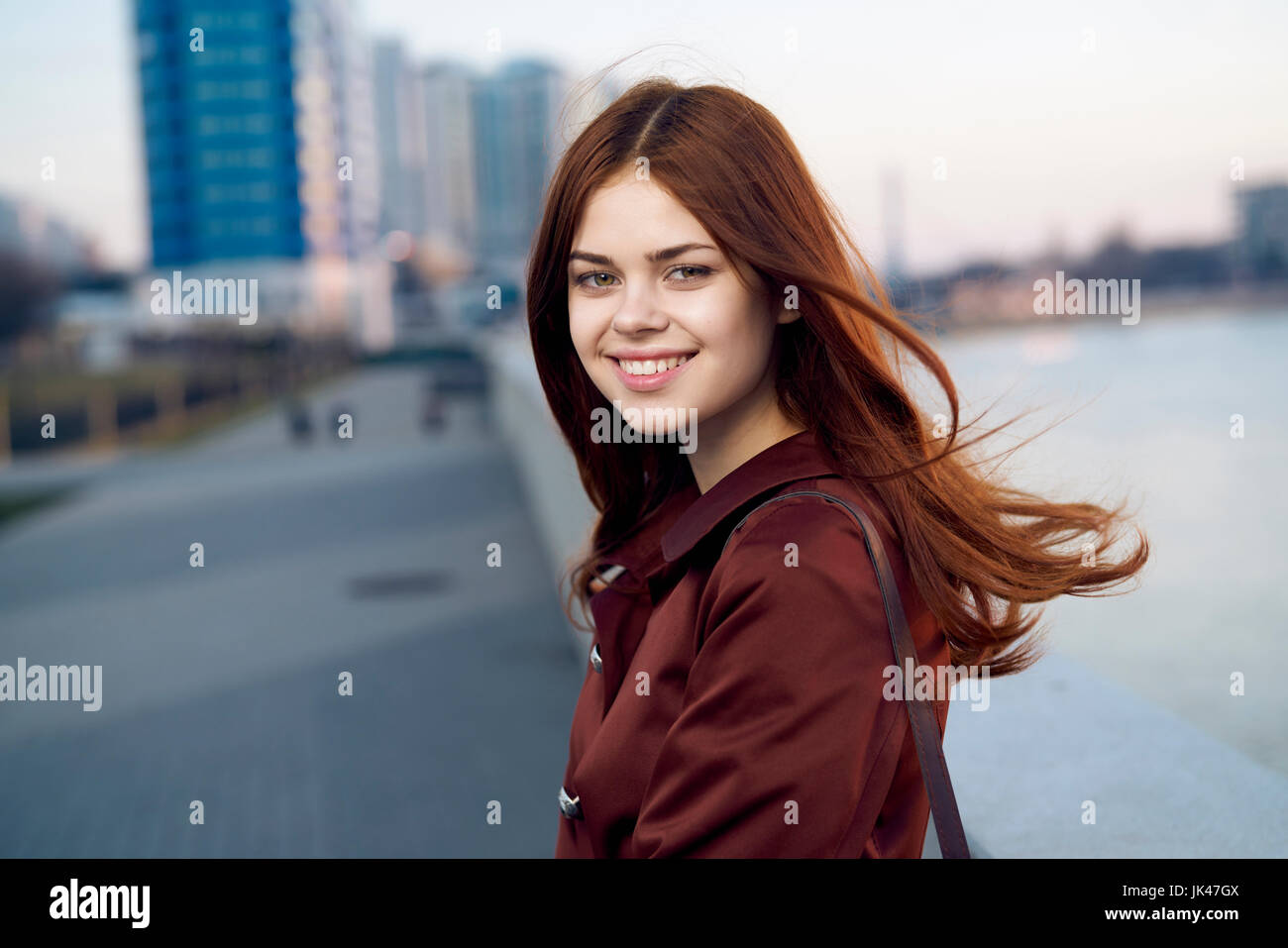 Smiling Caucasian woman at waterfront Stock Photo - Alamy