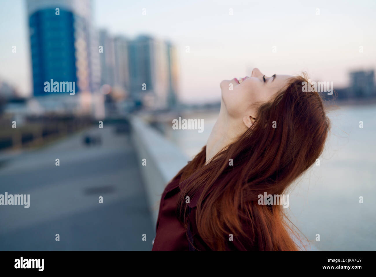 Smiling Caucasian woman at waterfront Stock Photo - Alamy