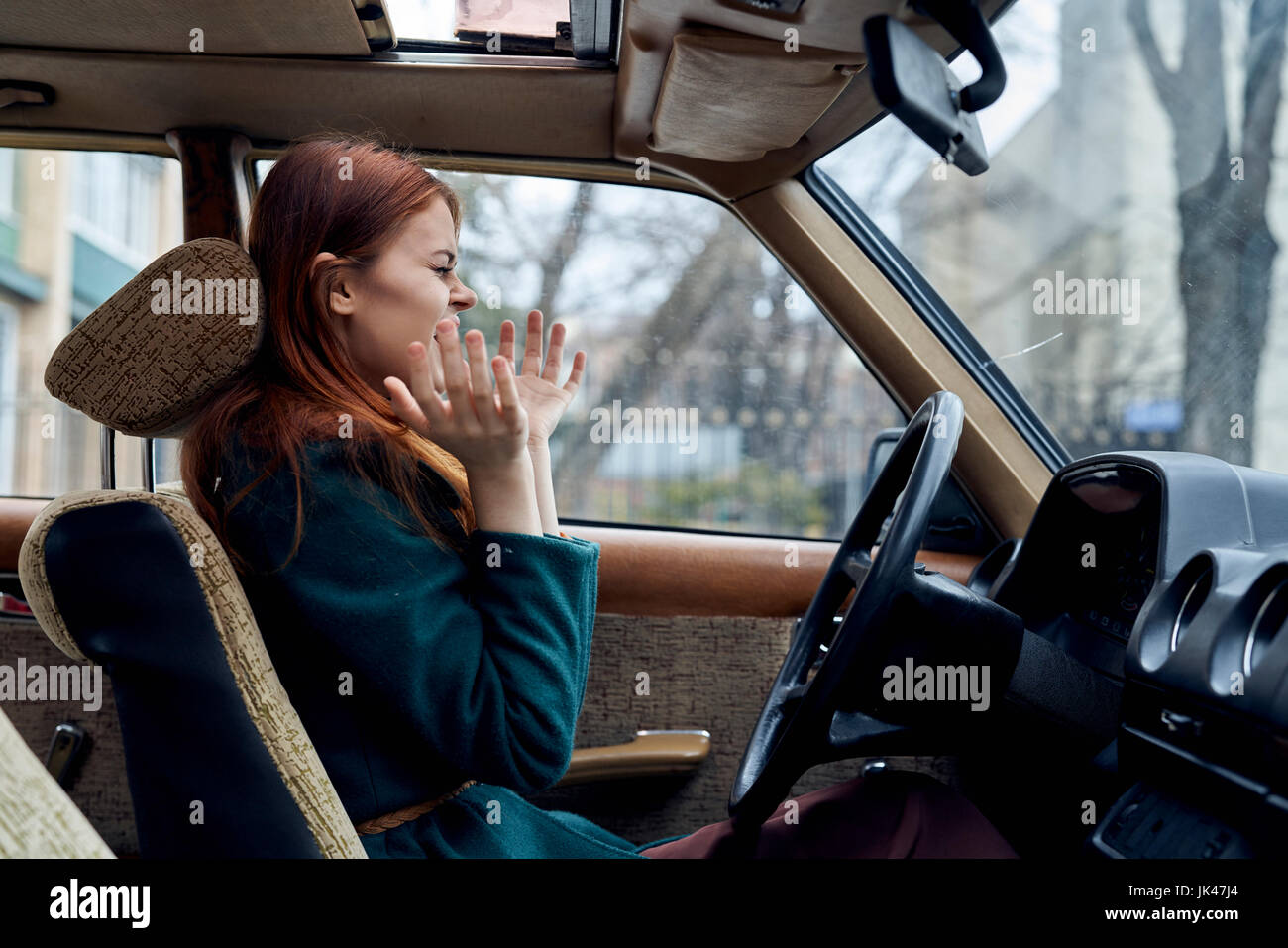 Excited Caucasian woman driving car Stock Photo