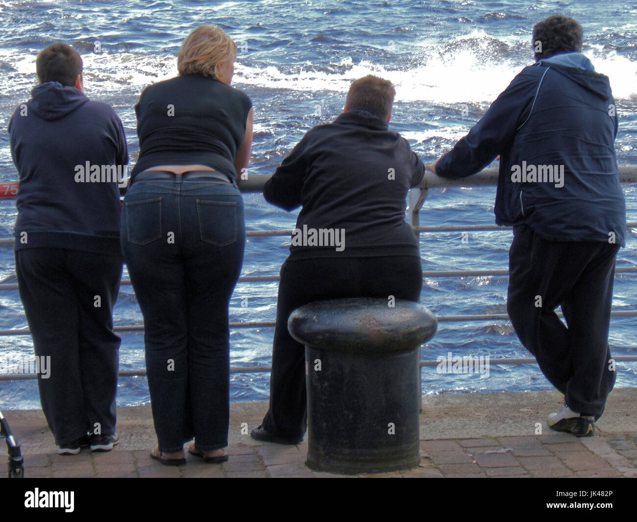 obese overweight fat family with bollard seat Stock Photo