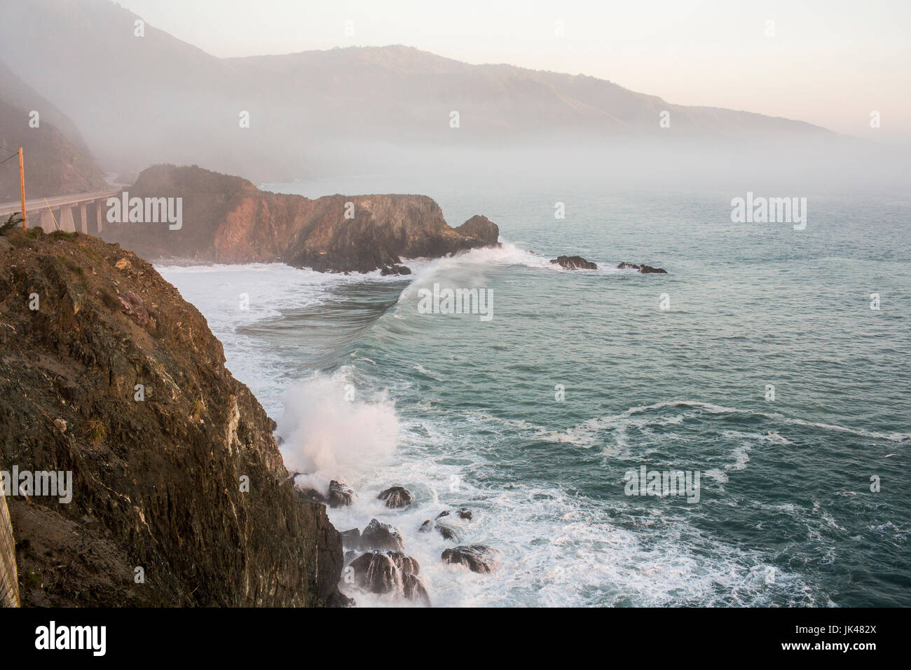 Waves splashing on rocks at cliffs Stock Photo