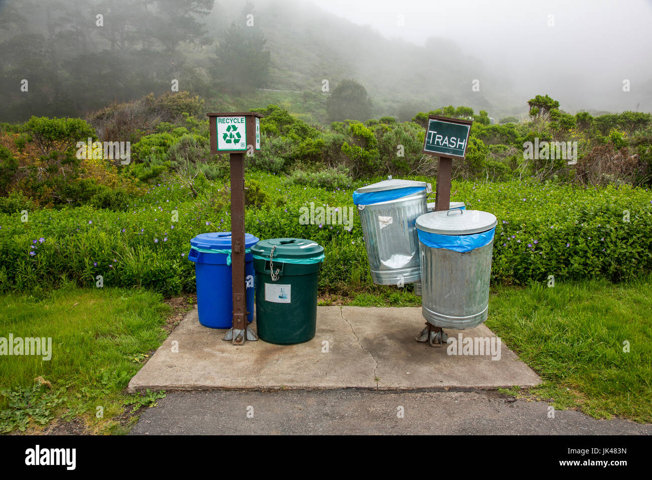 Trash and recycling bins in park Stock Photo