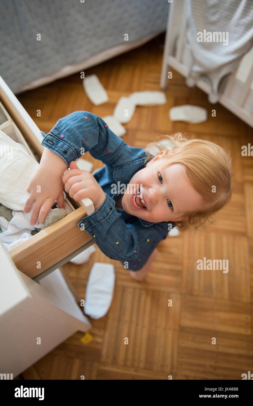 Caucasian girl throwing diapers on floor Stock Photo