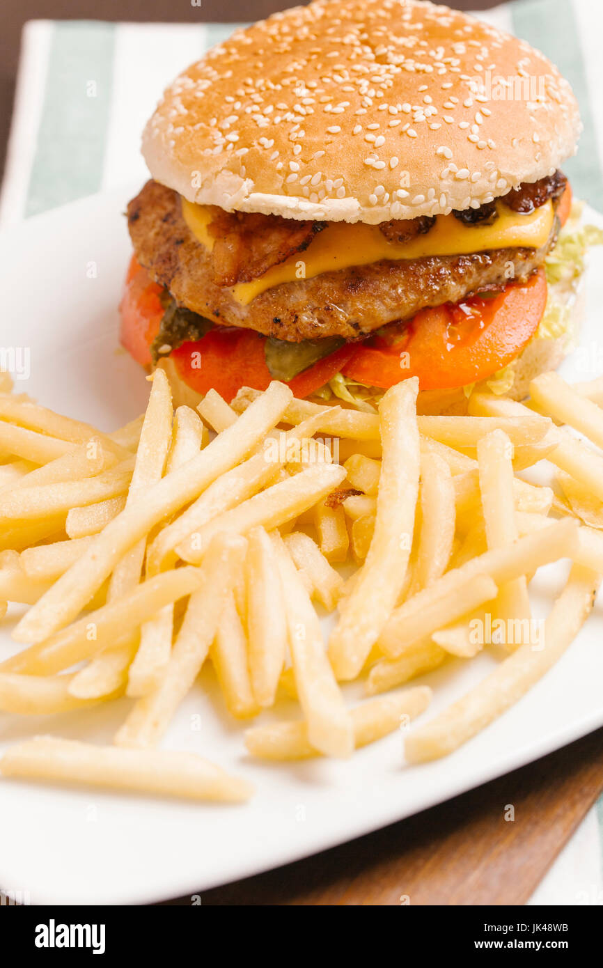 Cheeseburger with bacon and french fries Stock Photo