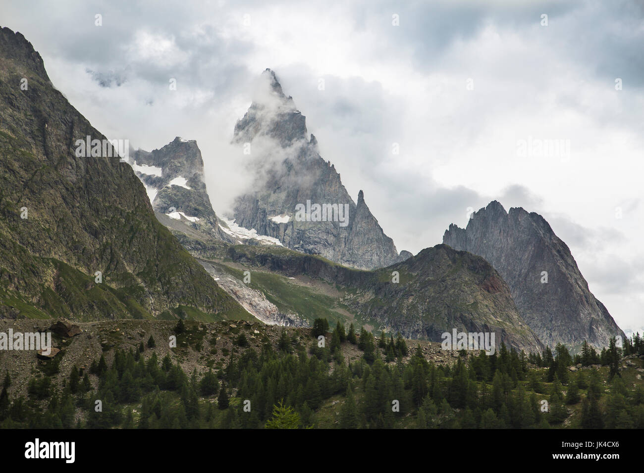 Cloudy ice covered mountains of the Alps near the Italian border along the Tour du Mont Blanc Stock Photo