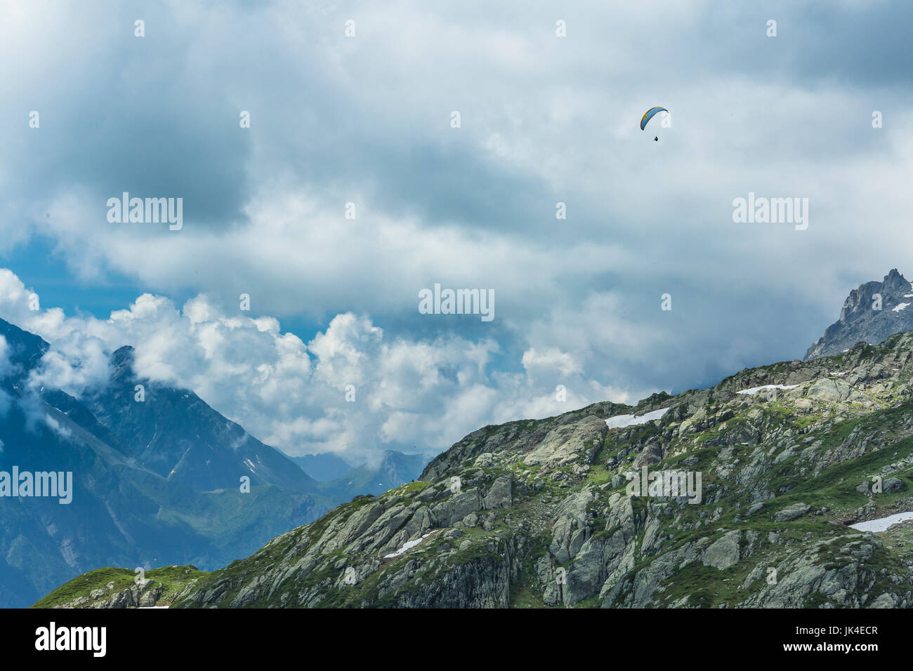 Parasailer flies over the ice and snow in the French Alps above Chamonix. Stock Photo