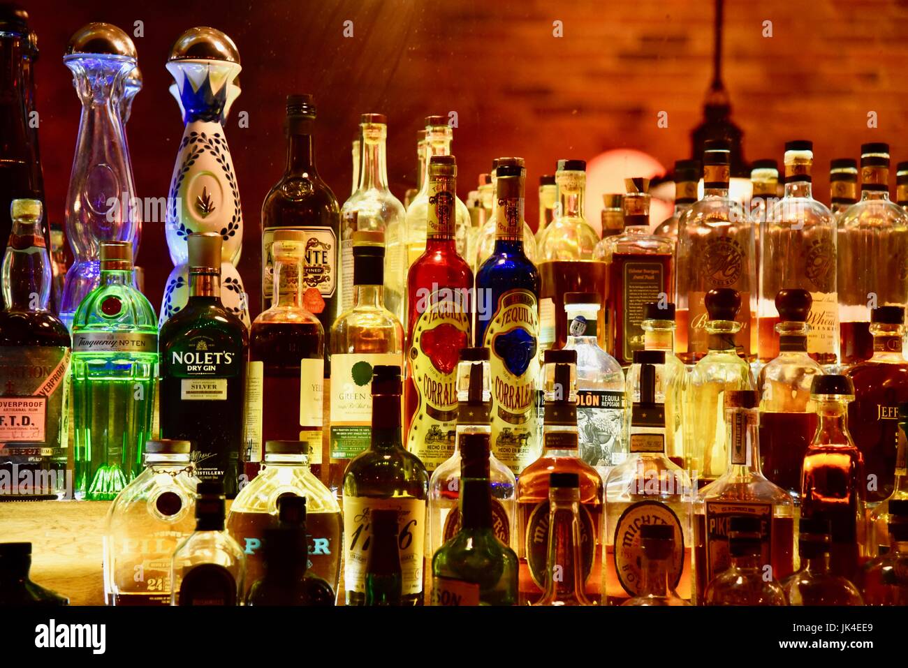 Back bar at The Ravens Club in Ann Arbor, Michigan, with spirits and bottles illuminated. Stock Photo