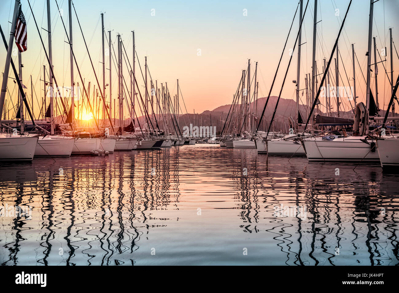Beautiful Sailboats Moored In The Dock Amazing View Of Gorgeous White Sail Boats Over Mountains Background In Mild Sunset Light Luxury Summer Vacati Stock Photo Alamy