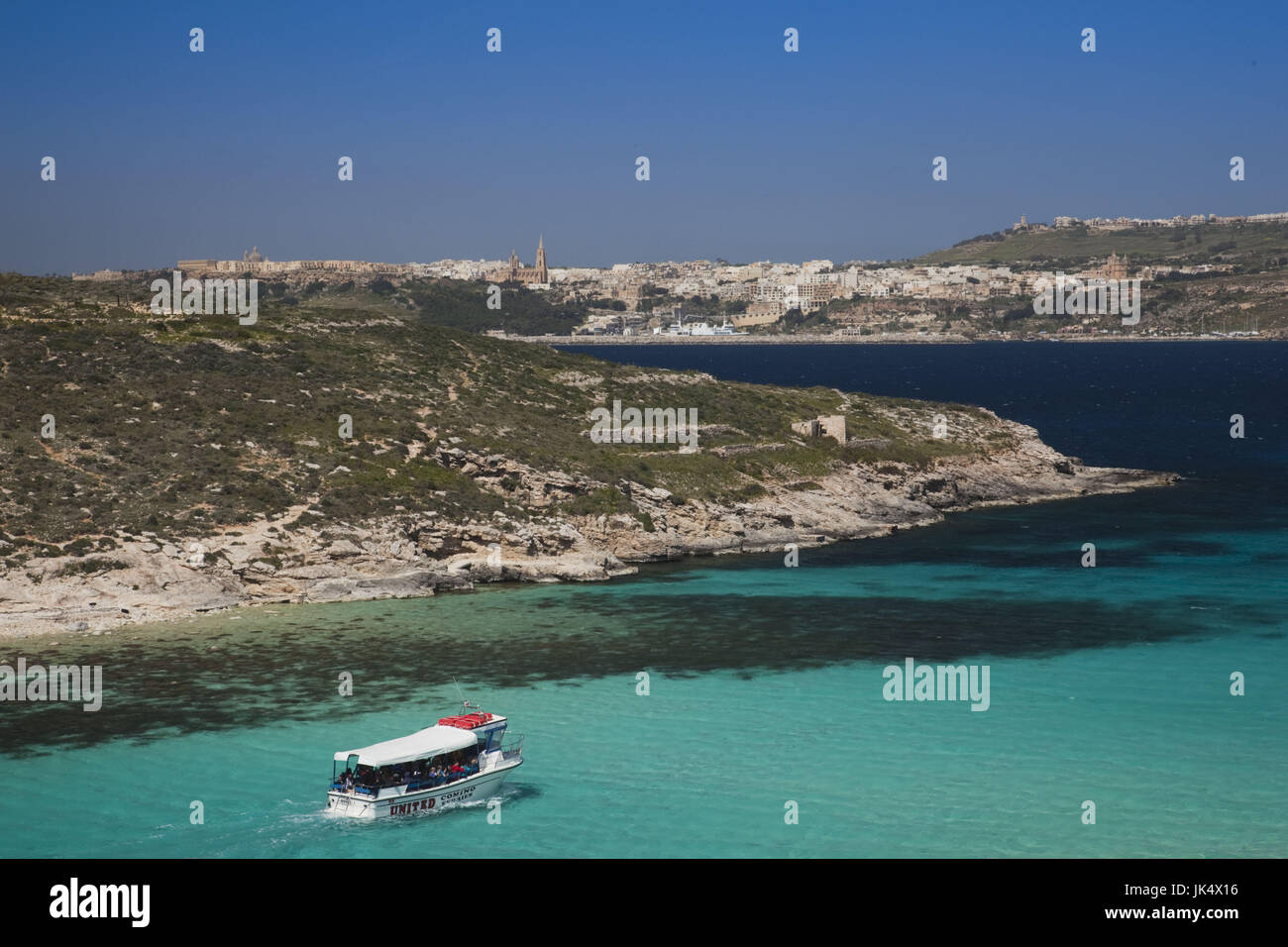 Malta, Comino Island, The Blue Lagoon with tour boat Stock Photo