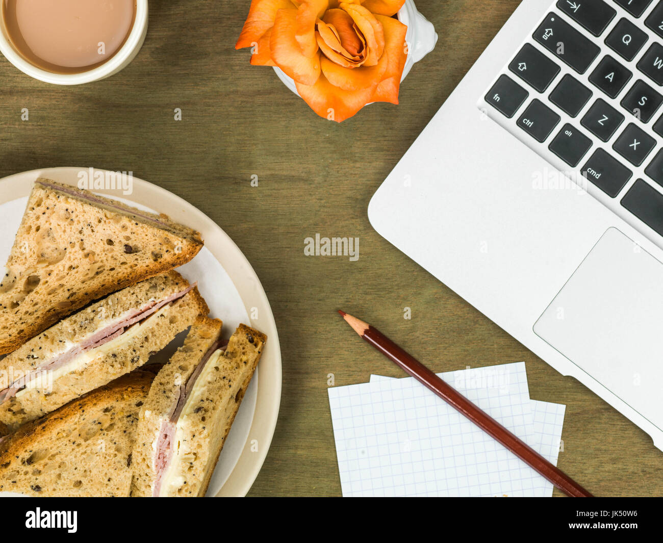 Ham and Cheese Sandwich in Brown Bread With a Cup of Tea At a Computer Workstation Stock Photo