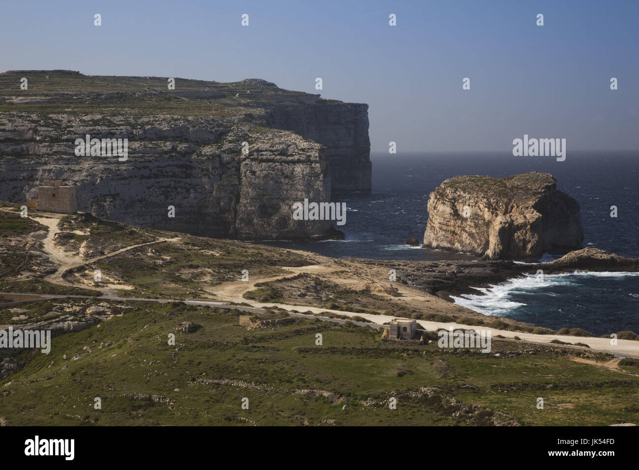 Malta, Gozo Island, Dwejra, coastal cliffs and Fungus Rock, only place in Europe where General's Root-cynomorium coccineus is found. This fungus was highly prized for its pharmaceutical properties in the Middle Ages. Stock Photo