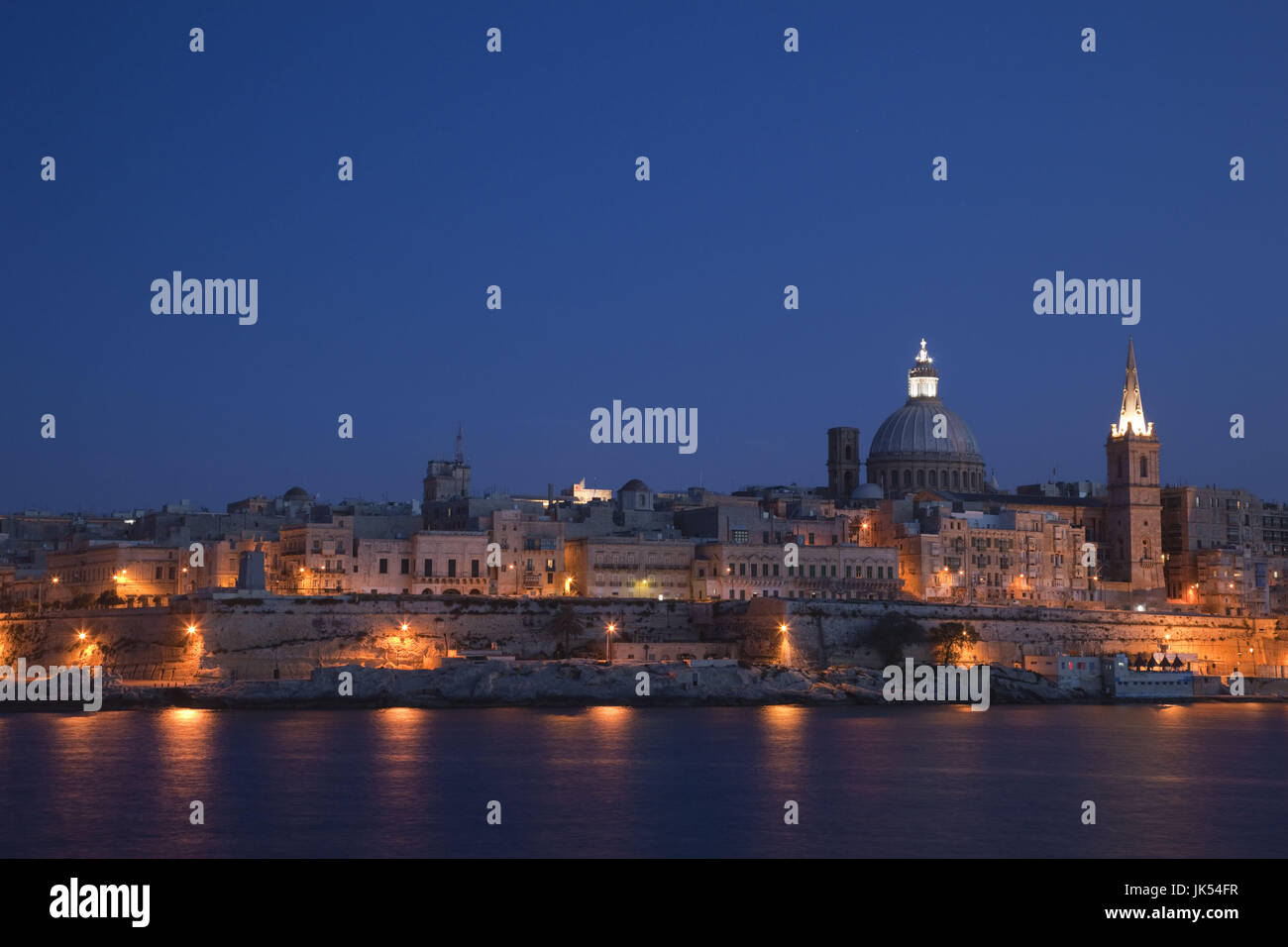 Malta, Valletta, skyline with St. Paul's Anglican Cathedral and Carmelite Church from Sliema, dusk Stock Photo
