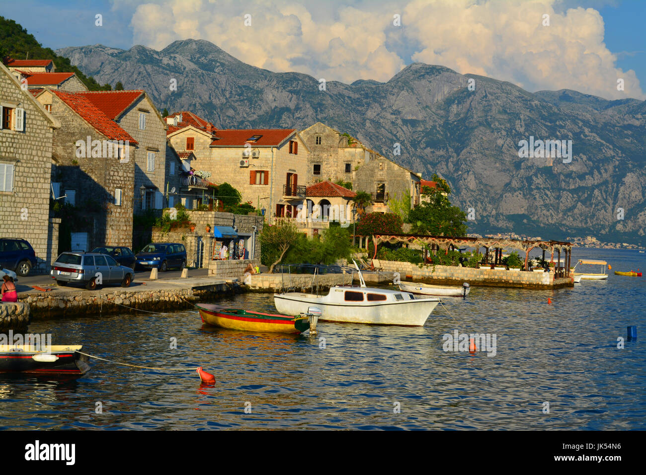 Coastal village in Montenegro boasting quaint harbour and colourful landscape Stock Photo