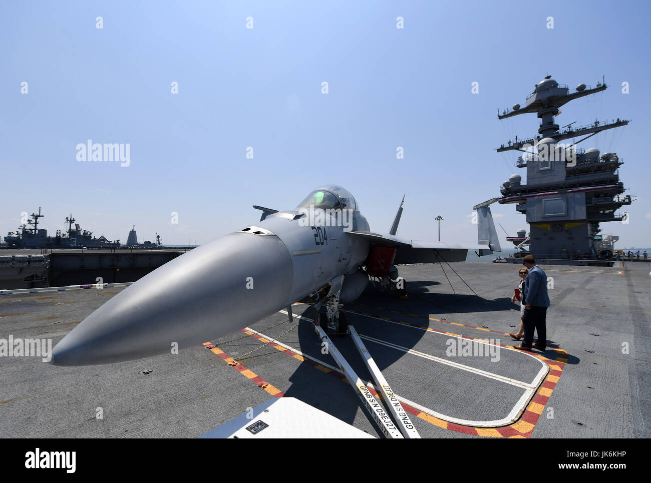 Norfolk, USA. 22nd July, 2017. Visitors view an F/A-18 Fighter on USS Gerald R. Ford after its commissioning ceremony at Naval Station Norfolk, Virginia, the United States, on July 22, 2017. The U.S. Navy commissioned United States Ship (USS) Gerald R. Ford, the newest and most advanced aircraft carrier, at Naval Station Norfolk, a navy base in Virginia on Saturday. Credit: Yin Bogu/Xinhua/Alamy Live News Stock Photo