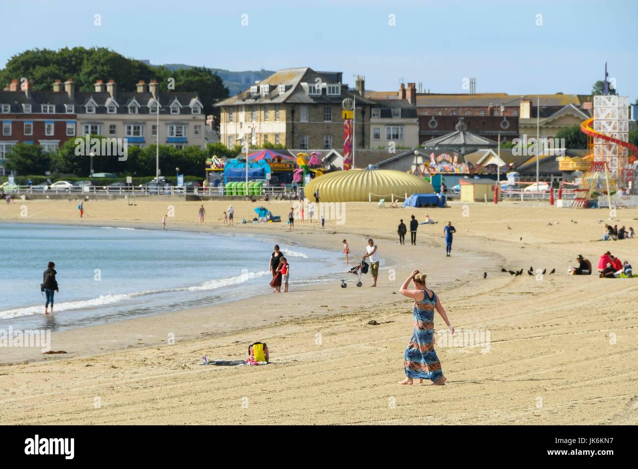 Weymouth, Dorset, UK.  23rd July 2017.   UK Weather. Holidaymakers at the beach making the most of the warm early morning sunshine at the seaside resort of Weymouth in Dorset.  Photo Credit: Graham Hunt/Alamy Live News Stock Photo