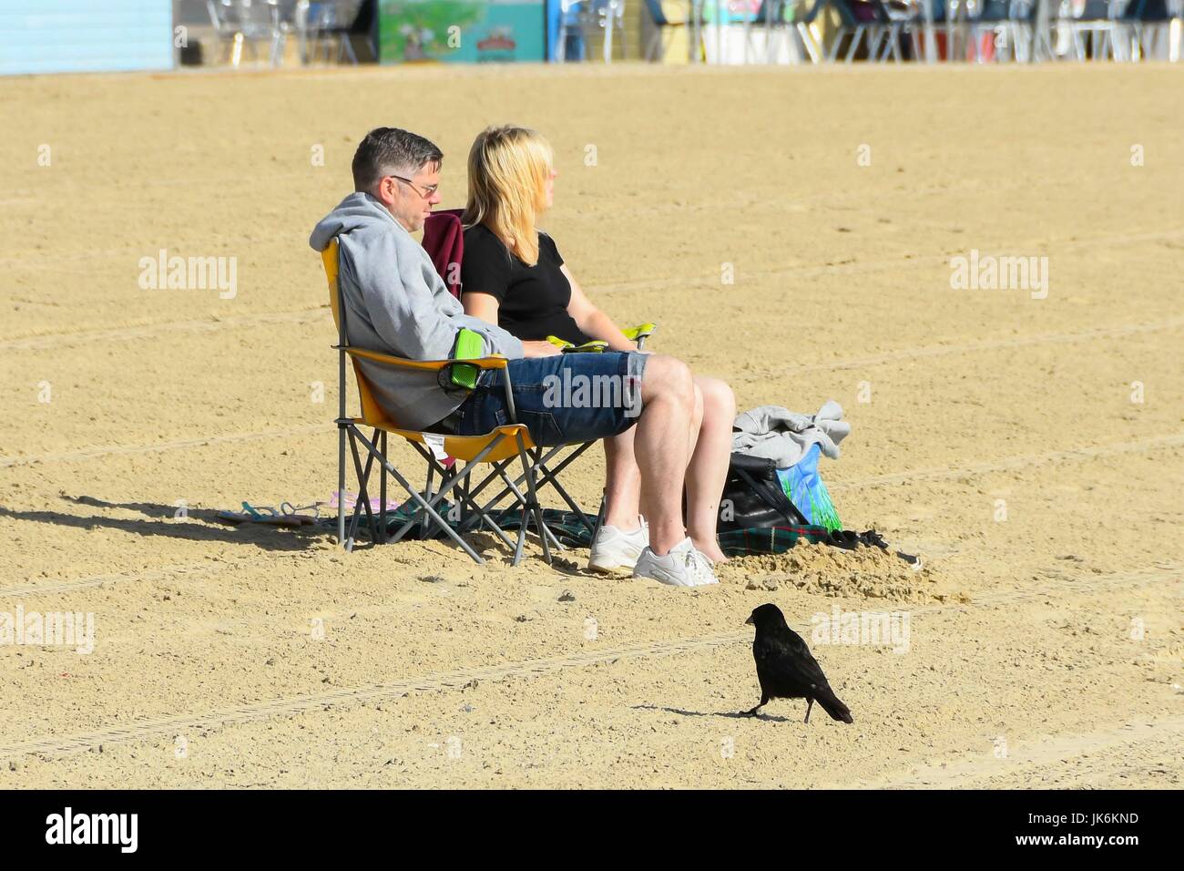 Weymouth, Dorset, UK.  23rd July 2017.   UK Weather. Holidaymakers at the beach making the most of the warm early morning sunshine at the seaside resort of Weymouth in Dorset.  Photo Credit: Graham Hunt/Alamy Live News Stock Photo
