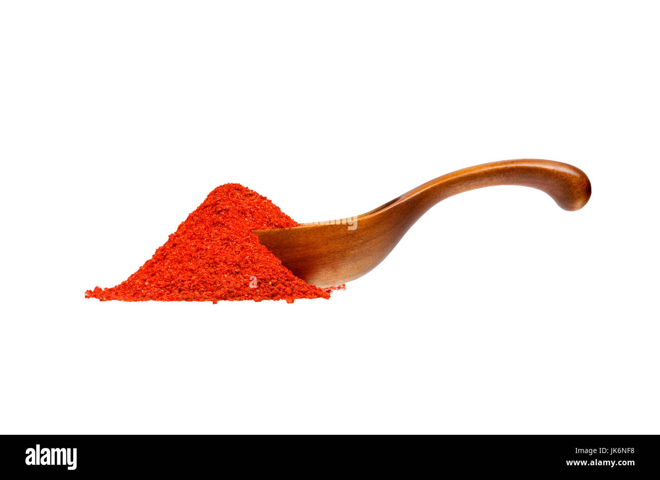 Powdered pimienta roja red pepper in the wooden spoon. Stock Photo