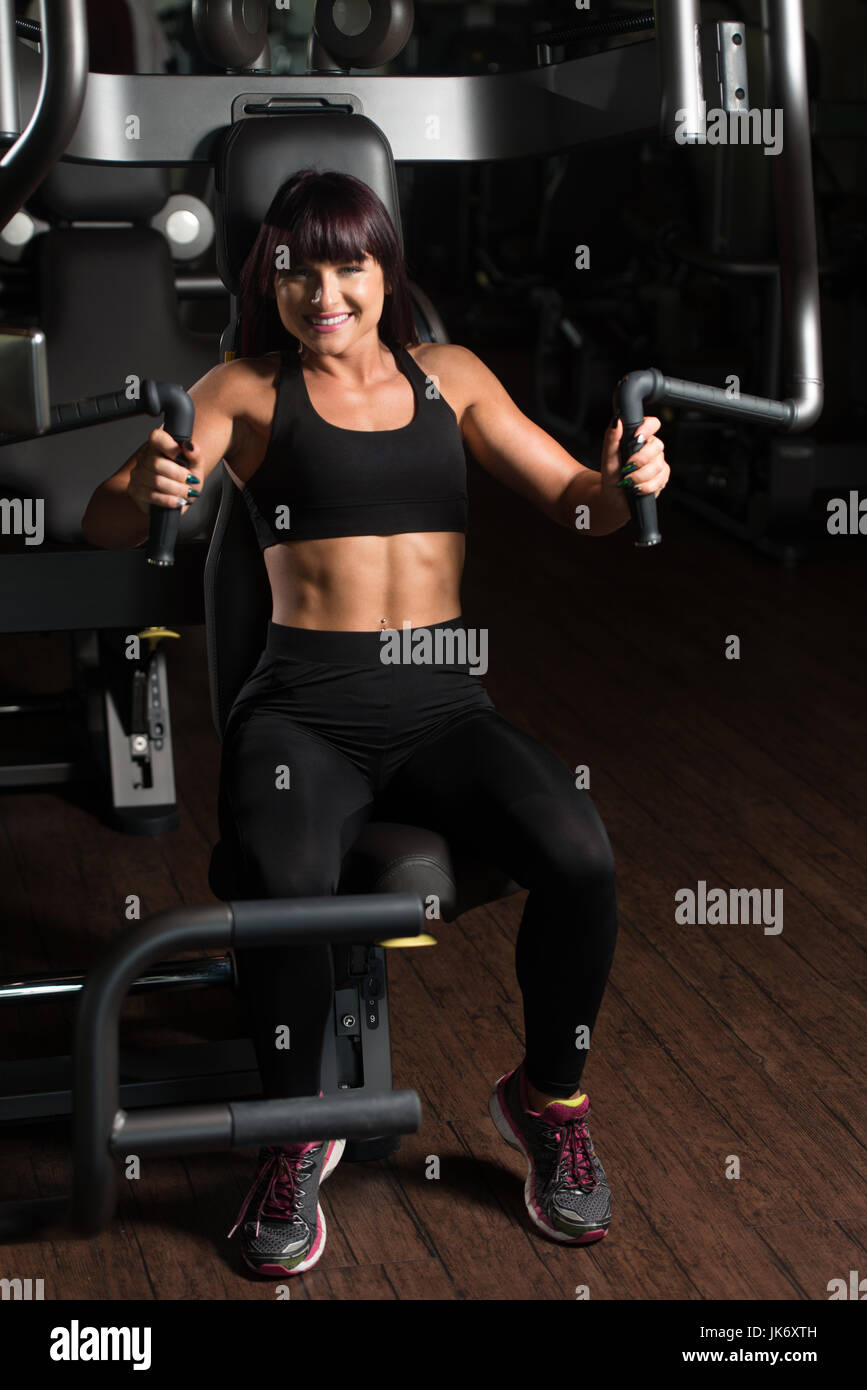 Woman flexing muscles on chest hi-res stock photography and images