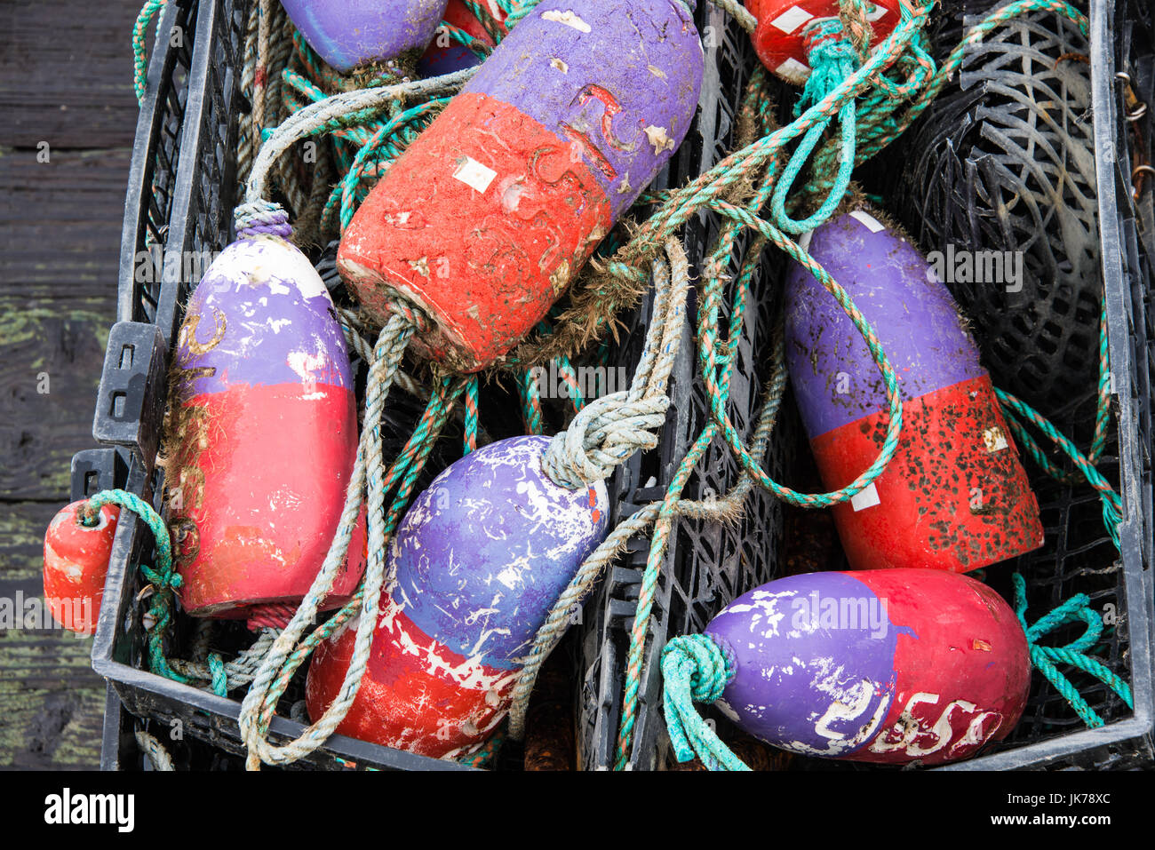 Detail of Old Colorful Crab Pot Buoys on Deck Stock Photo