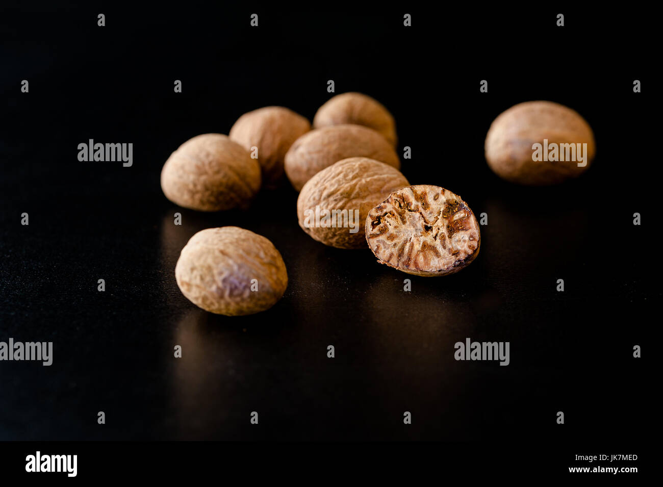 Nutmeg nuts and powder isolated on dark background Stock Photo Alamy