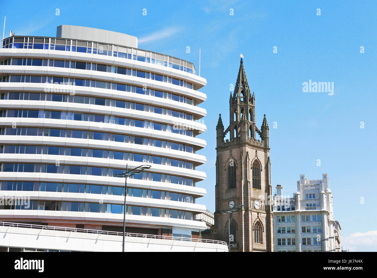 The old and the new.Our Lady and St Nicholas Parish Church next to the Mercure Liverpool Atlantic Tower Hotel,Liverpool,UK Stock Photo