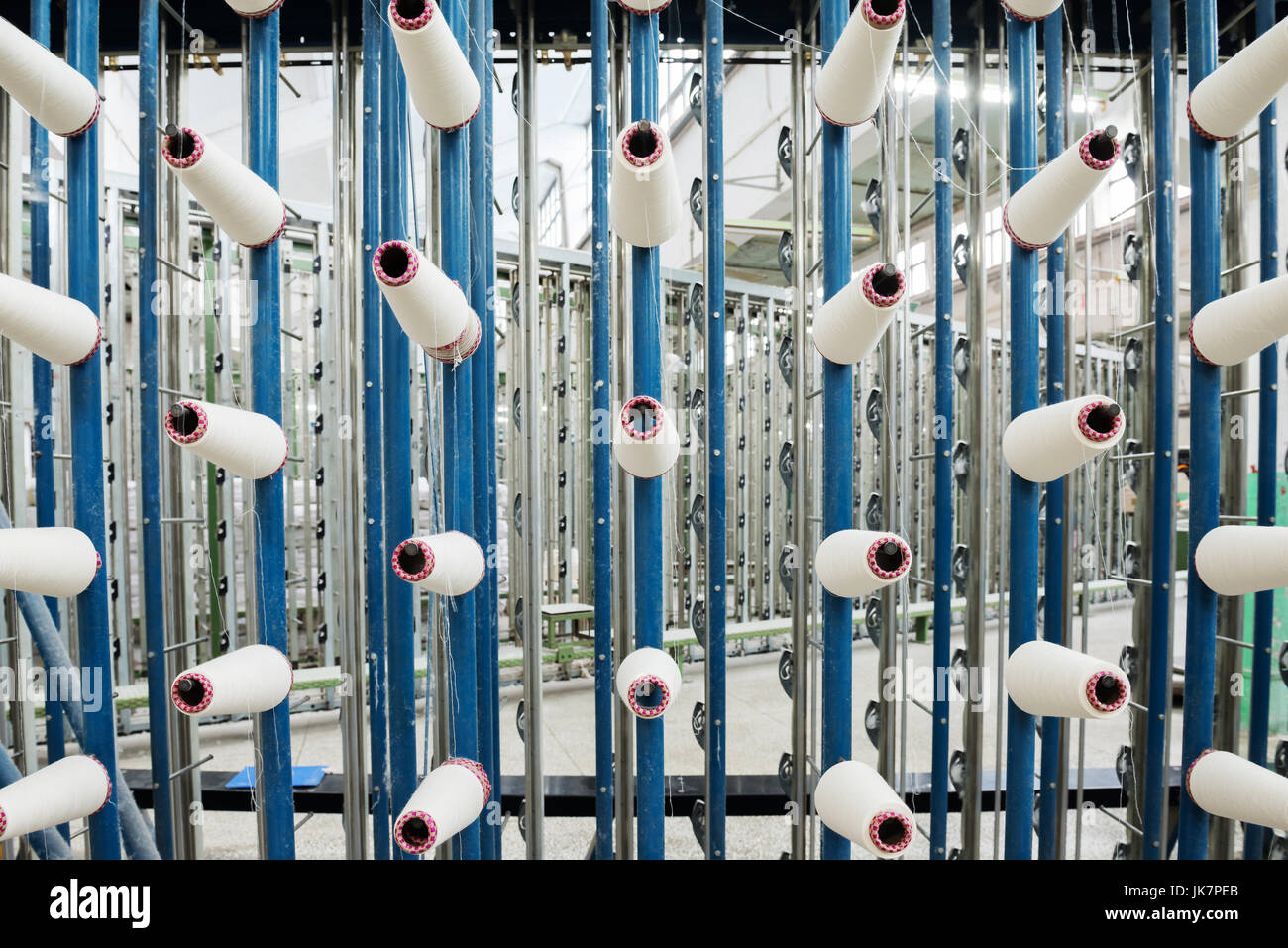 large group of bobbin thread cones on a warping machine in a textile ...