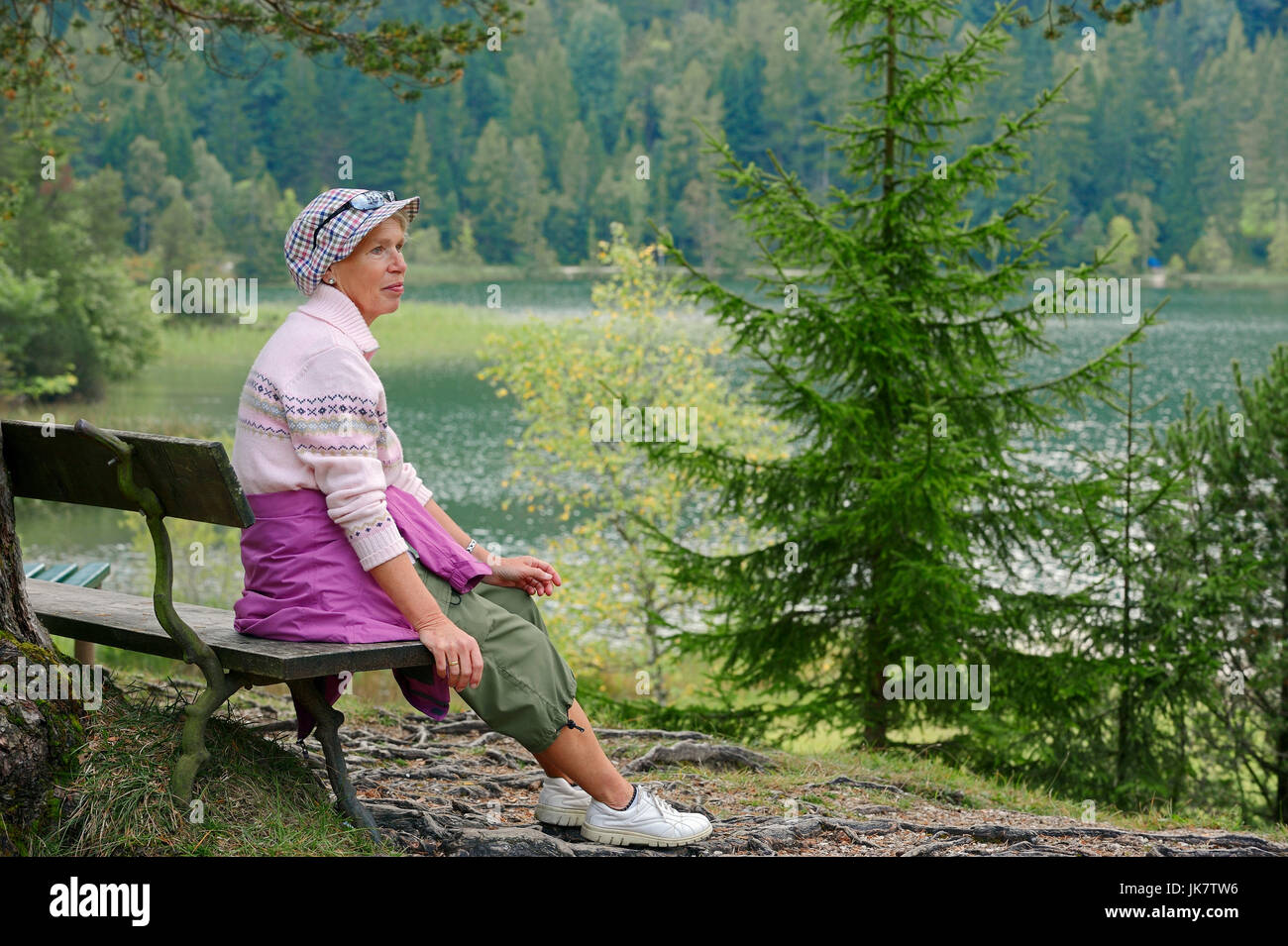 Woman resting on bench at lake Lautersee, Werdenfelser Land, Bavaria, Germany | Frau rastet auf Bank am Lautersee, Werdenfelser Land Stock Photo