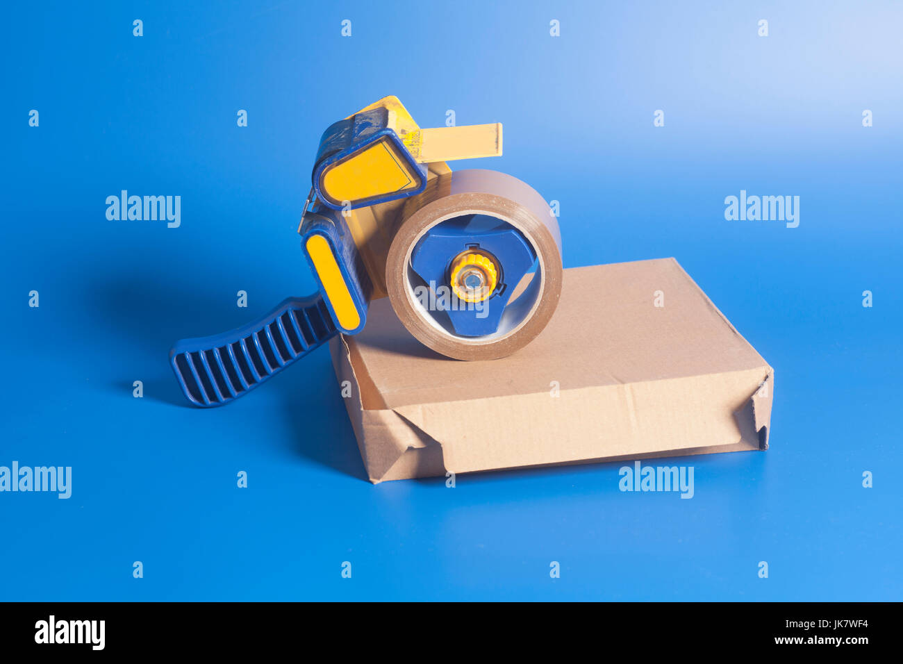 Industrial tape dispenser on a cardboard box Stock Photo Alamy