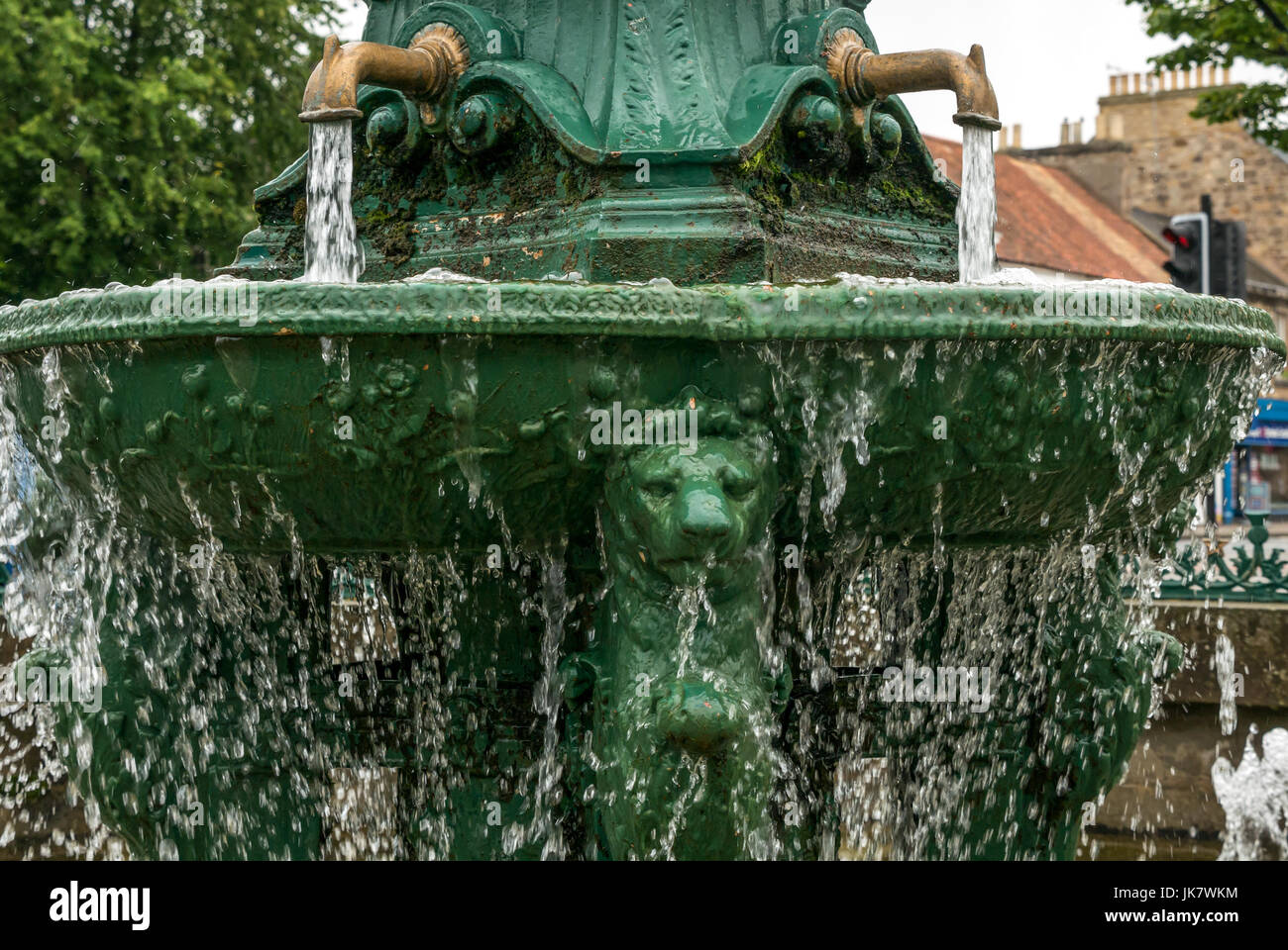 Cast iron drinking fountain, Place d’Aubigny, Court Street, Haddington, East Lothian, Scotland, UK, with running water, lion heads and gold taps Stock Photo