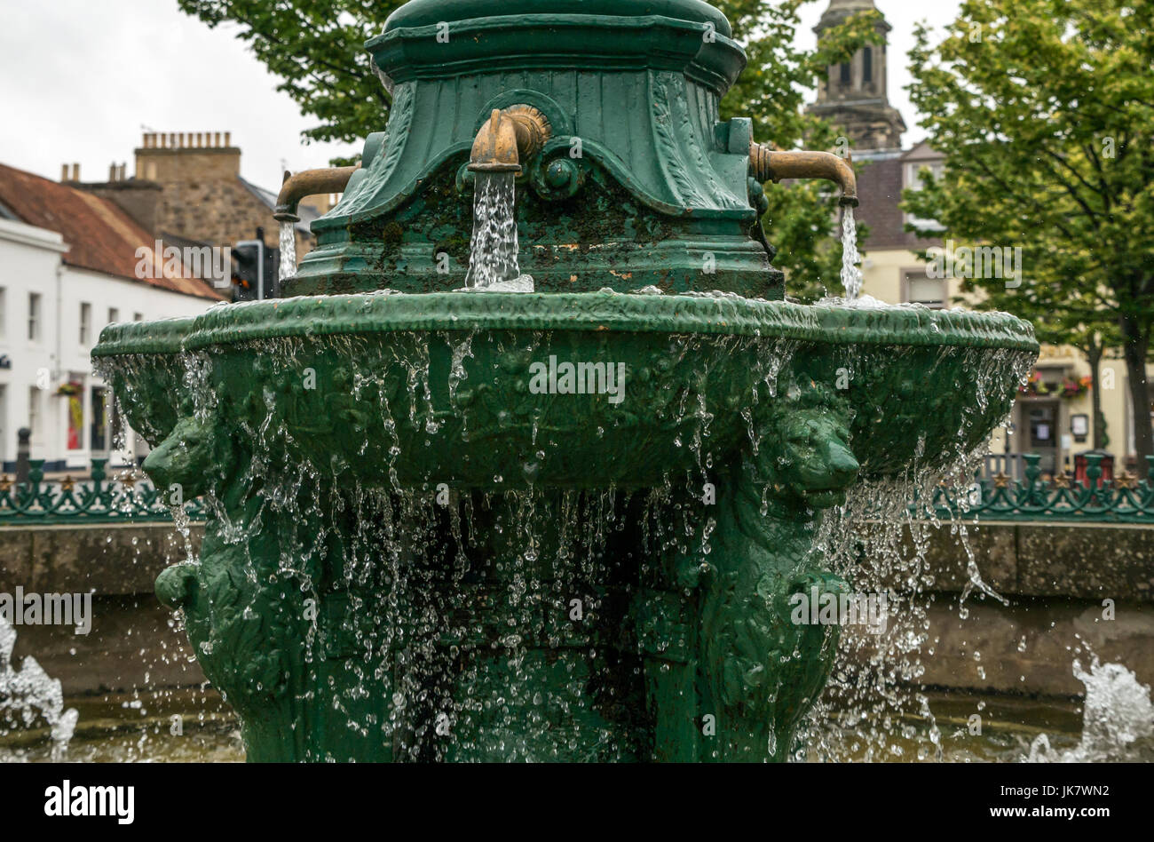 Cast iron drinking fountain, Place d’Aubigny, Court Street, Haddington, East Lothian, Scotland, UK, with running water, lion heads and gold taps Stock Photo