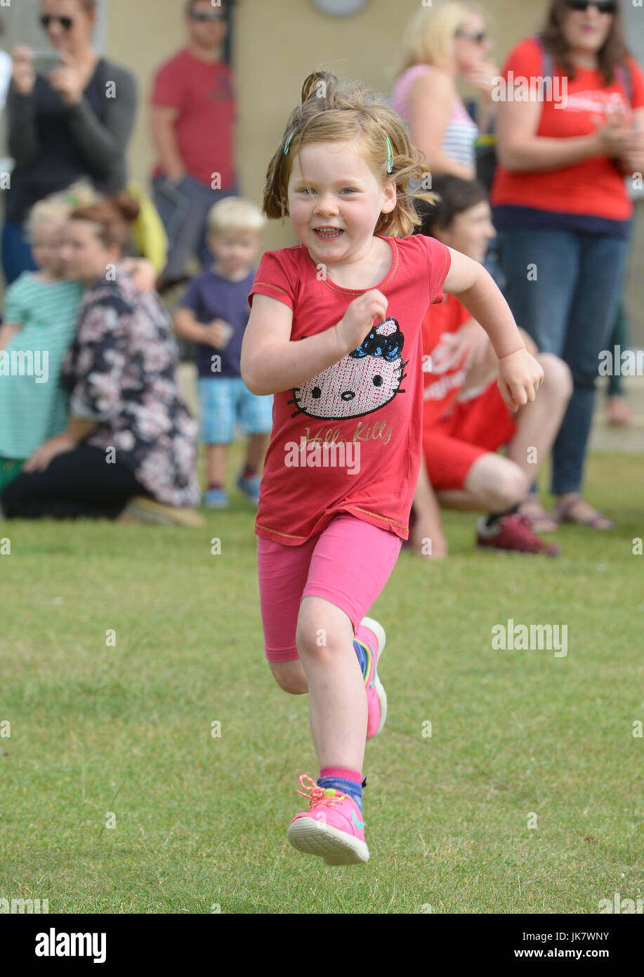 Girl running during school sports day Stock Photo