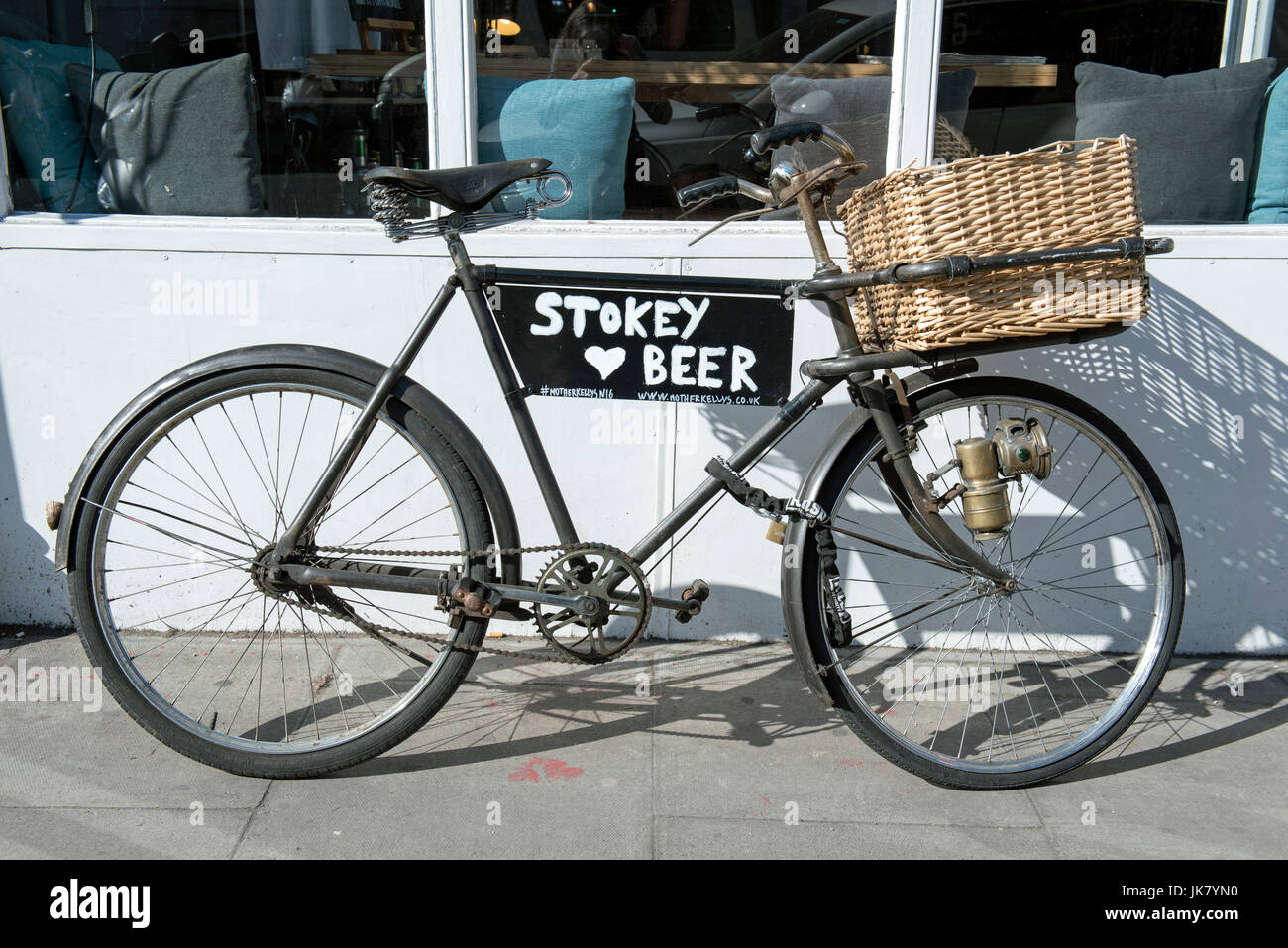 Stokey Beer on side of  vintage delivery bike, Stoke Newington Church Street, London Borough of Hackney, England Britain UK Stock Photo