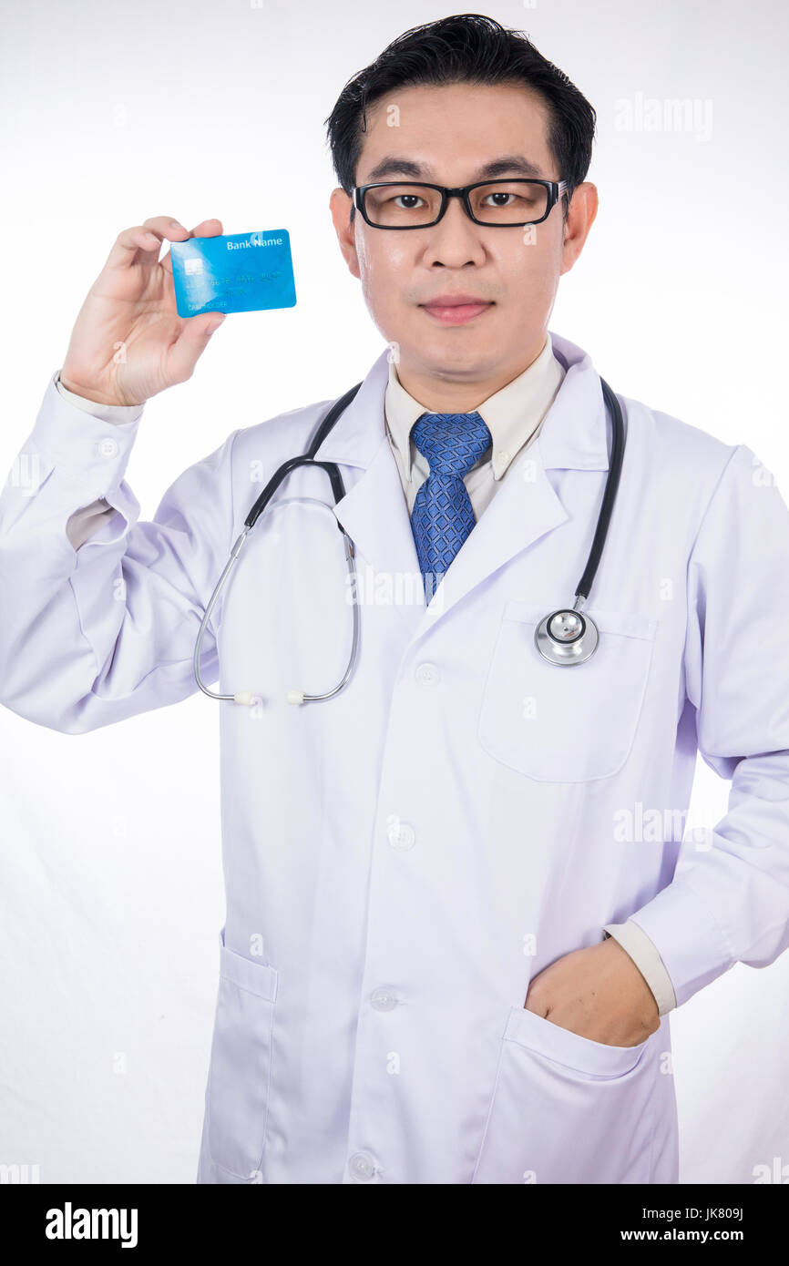 Asian Chinese male doctor holding credit card with stethoscope in ...