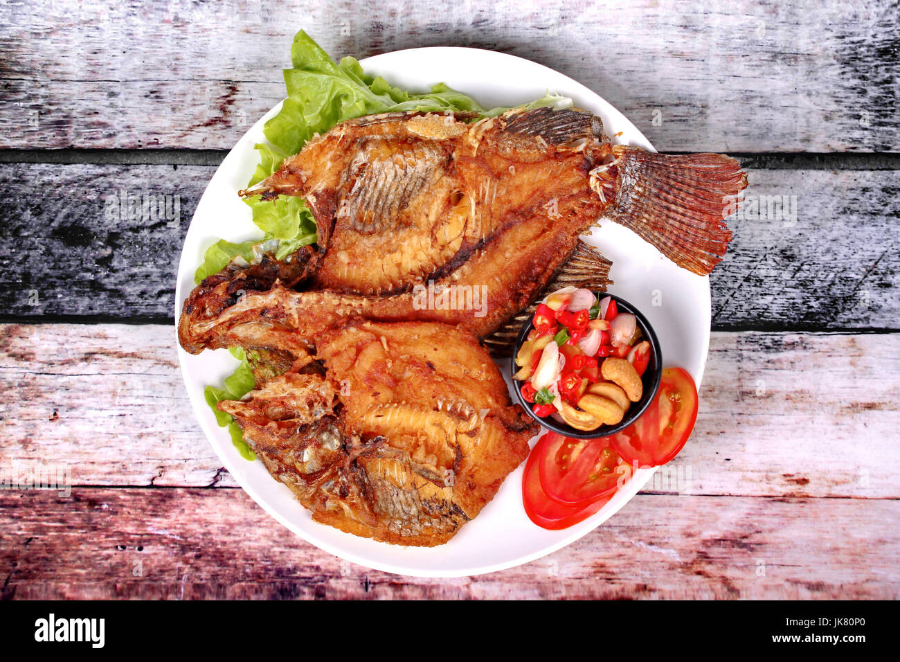 Thai cuisine,Deep fried Tilapia with spicy and sour herb salad Stock ...