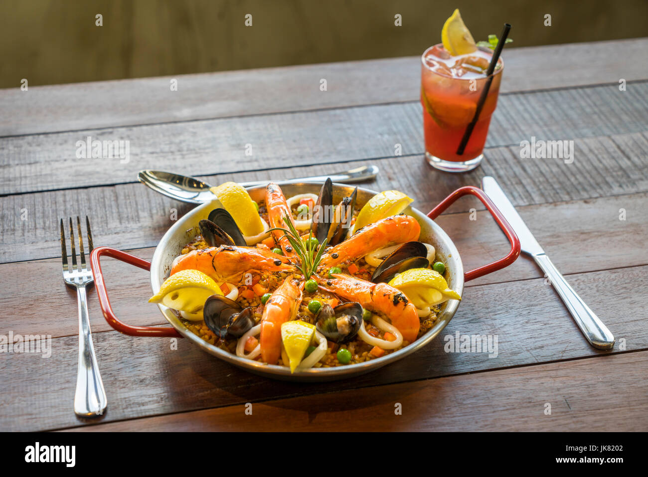 Paella with seafood vegetables and saffron served in the traditional pan. Stock Photo
