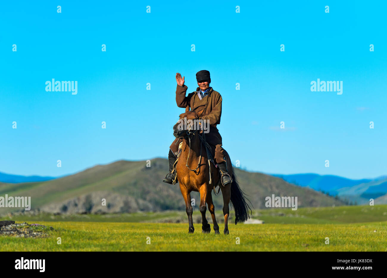 Horseman greeting in the steppe, Orkhon Valley, Mongolia Stock Photo
