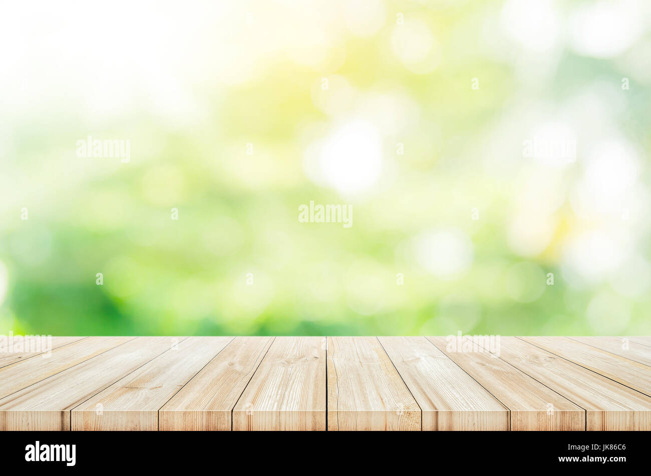 Empty wooden table top with blurred green garden background. can be ...
