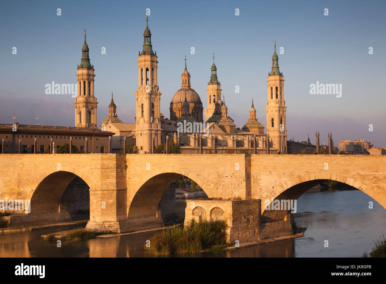 Spain, Aragon Region, Zaragoza Province, Zaragoza, Basilica de Nuestra Senora de Pilar and the Puente de Piedra bridge, on the Ebro River, sunrise Stock Photo