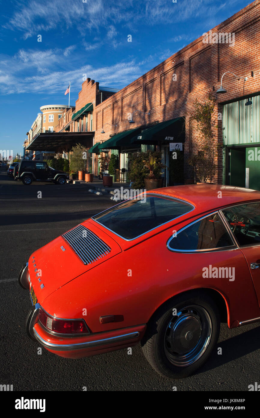 Renovated warehouses along the napa river with 1970s porsche 911 hires