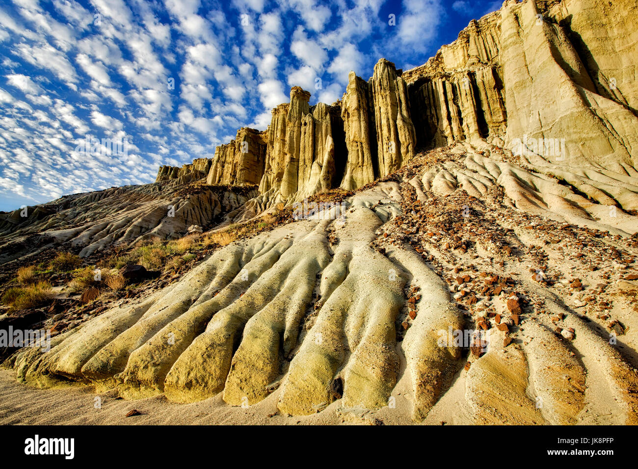 Eroded cliff with puffy clouds. Red Rock Canyon State Park, California Stock Photo