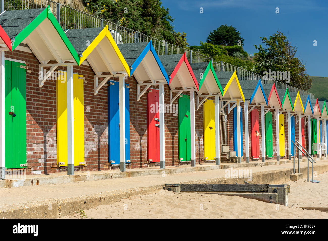 Row of colourful beach huts on a sunny day Stock Photo - Alamy